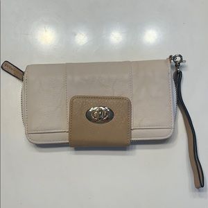 Cream colored clutch with brown and gold trim.